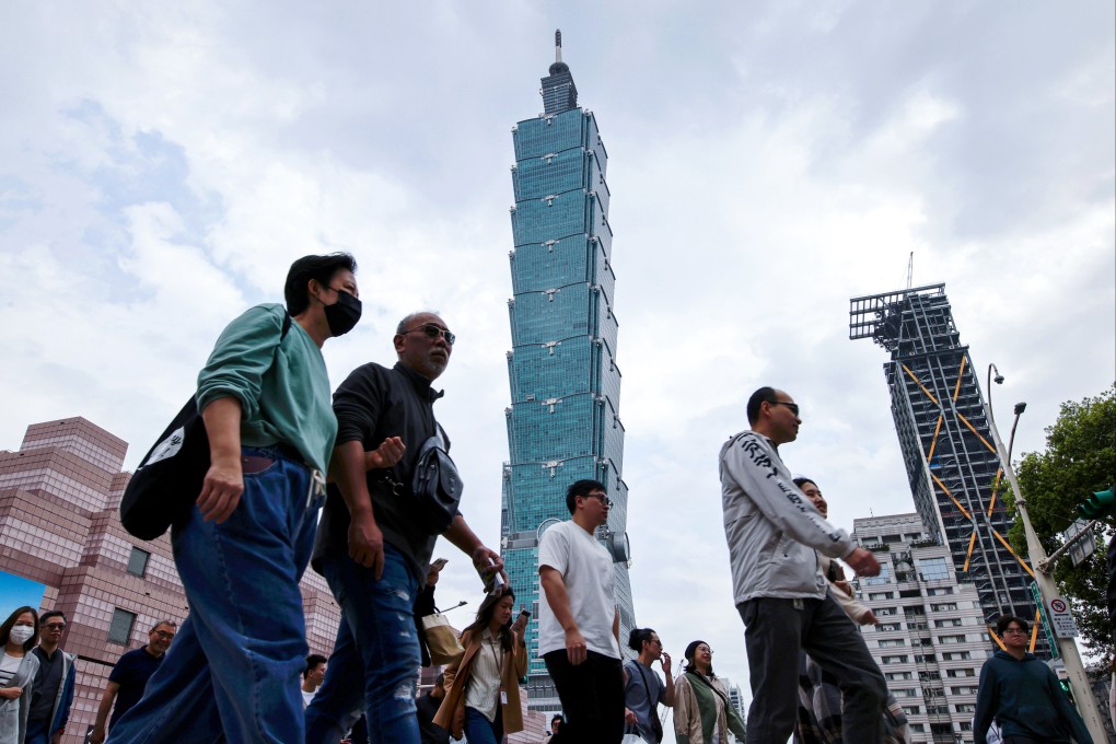 People walk past the Taipei 101 skyscraper in Taipei, Taiwan, on April 7. An official commentary published by Xinhua stated that after peaceful reunification, Taiwan’s current social system and way of life would be fully respected. Photo: EPA-EFE