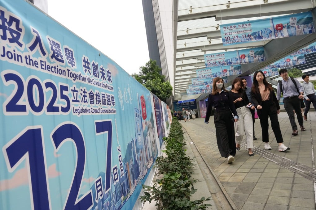 People walk past banners publicising the December 7 Legislative Council election at the government offices in Tamar on October 30. Photo: Jelly Tse