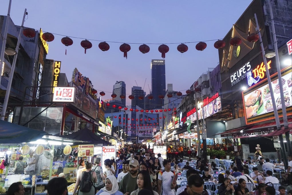 People crowd the Bukit Bintang shopping area in Kuala Lumpur, Malaysia, in July. Photo: NurPhoto via Getty Images