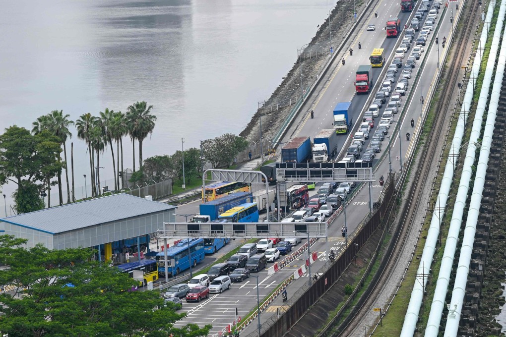 An aerial view of the causeway linking Singapore to Malaysia shows water pipes running along its length. Photo: AFP