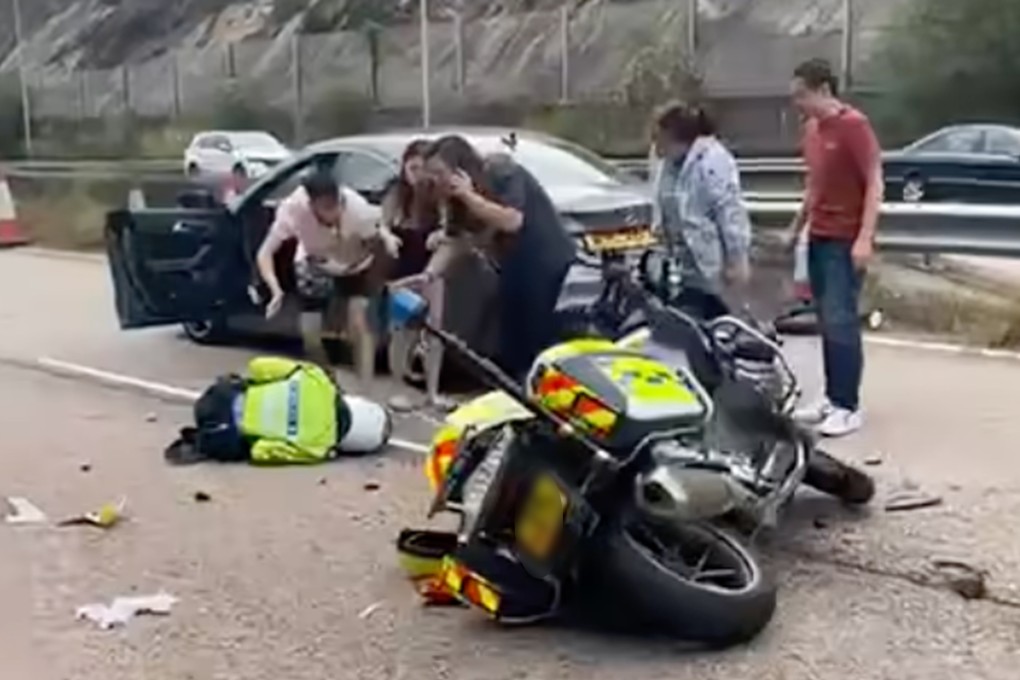 A Hong Kong police motorcycle has collided with a Mercedes-Benz limousine on a highway leading to Tai Lam Tunnel, injuring an officer and two others. Photo: Handout