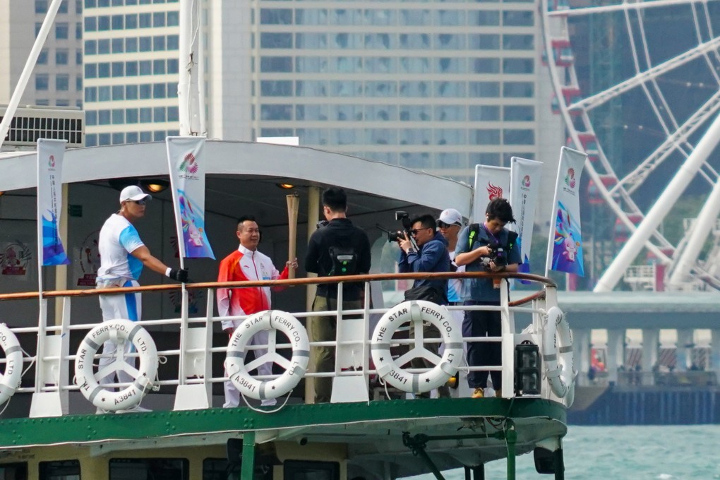 The torch crosses Victoria Harbour on the Star Ferry for the relay event. Photo: Felix Wong