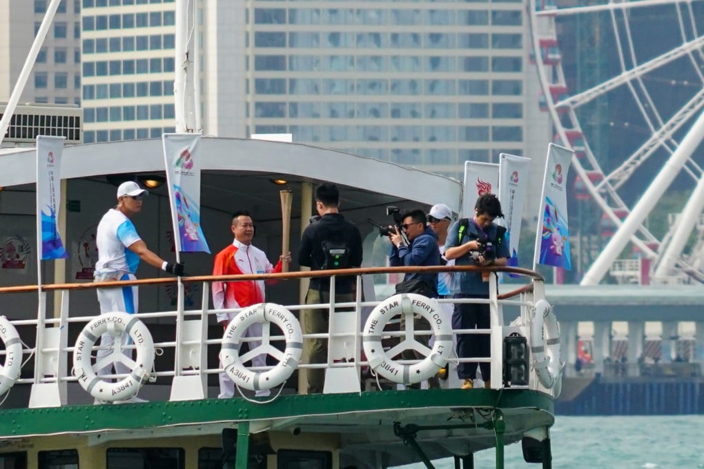 The torch crosses Victoria Harbour on the Star Ferry for the relay event. Photo: Felix Wong
