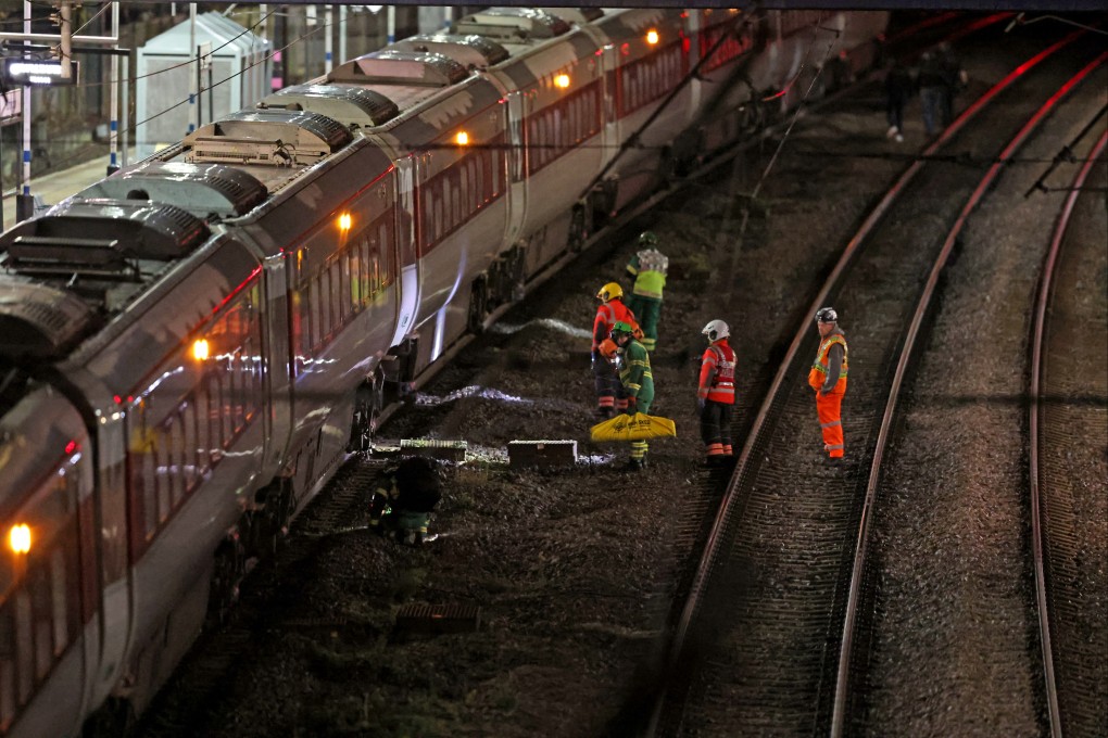 Emergency responders stand beside a train at Huntingdon station in Cambridgeshire after multiple people were stabbed on Saturday. Photo: PA Wire/dpa
