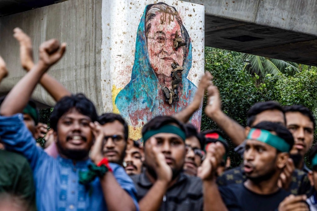 Students chant slogans near a vandalised mural of Bangladesh’s ousted former prime minister Sheikh Hasina, during a protest demanding accountability and trial against Hasina, near Dhaka University in the capital on August 12 last year. Photo: AFP