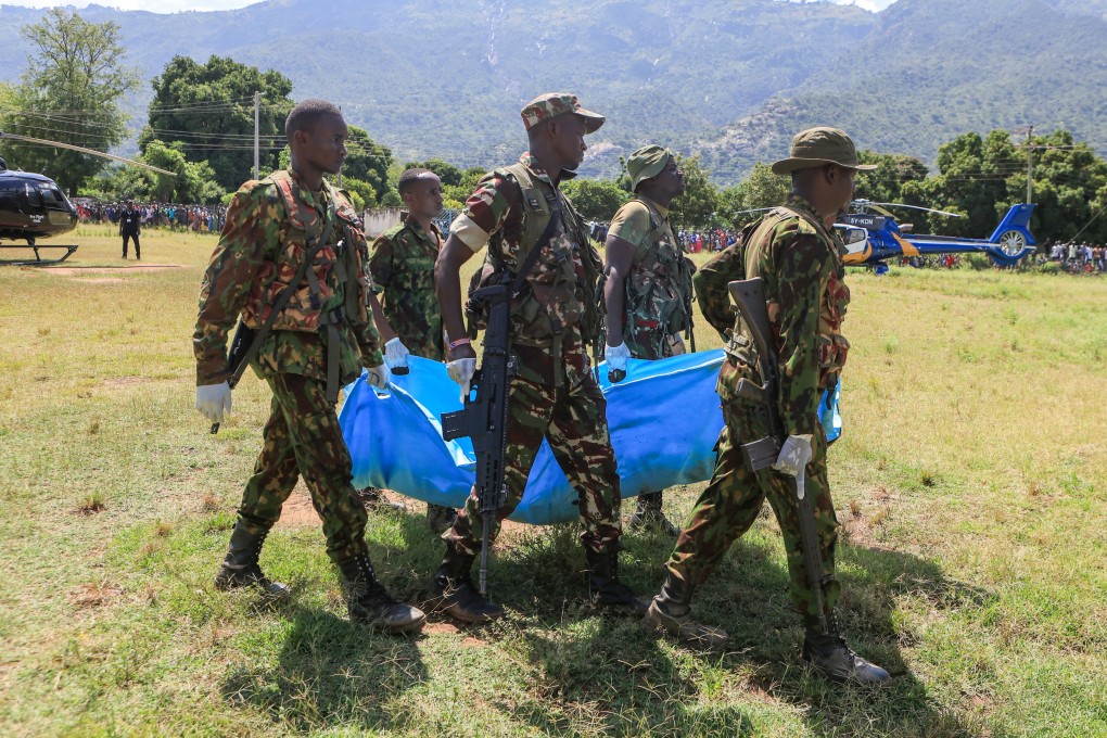 Rescue teams carry bodies of victims of a landslide in the hilly area of Chesongoch in Elgeyo Marakwet county, western Kenya on Sunday. Photo: AP