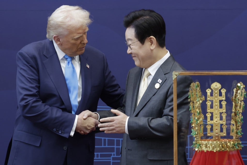South Korean President Lee Jae-myung (right) shakes hands with US President Donald Trump after presenting him with a replica of a Silla-era gold crown on Wednesday. Photo: EPA/Yonhap