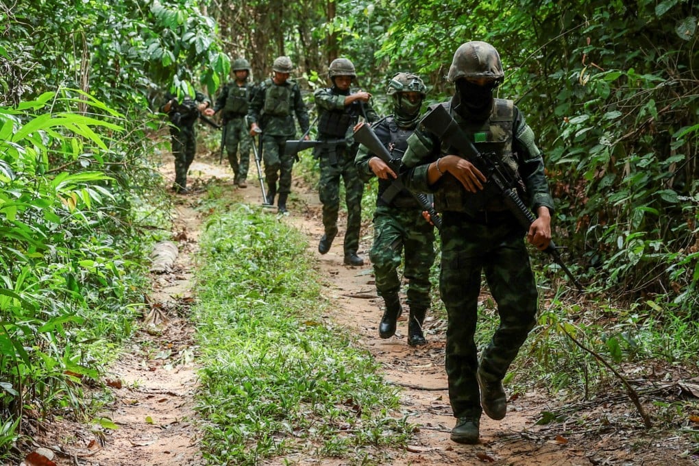 Thai military personnel walk near the forested disputed border between Thailand and Cambodia in the Chong Bok area in August. Photo: Reuters