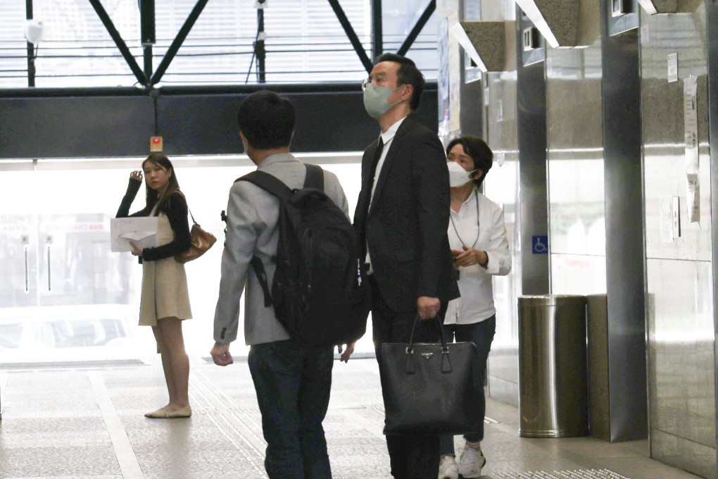 Henry Kwok (second from right) arrives at the District Court for an earlier hearing. Photo: Brian Wong