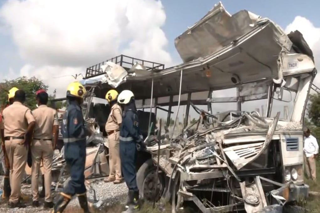 Authorities inspect the remains of a passenger bus after it collided with a truck loaded with concrete stone chips on Monday. Photo: Handout