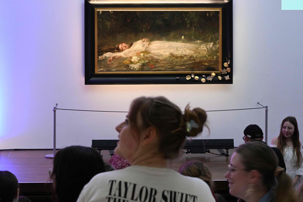 Taylor Swift fans listen to a lecture about the painting “Ophelia” by German artist Friedrich Heyser during a tour at Museum Wiesbaden in western Germany on Sunday. Photo: AFP