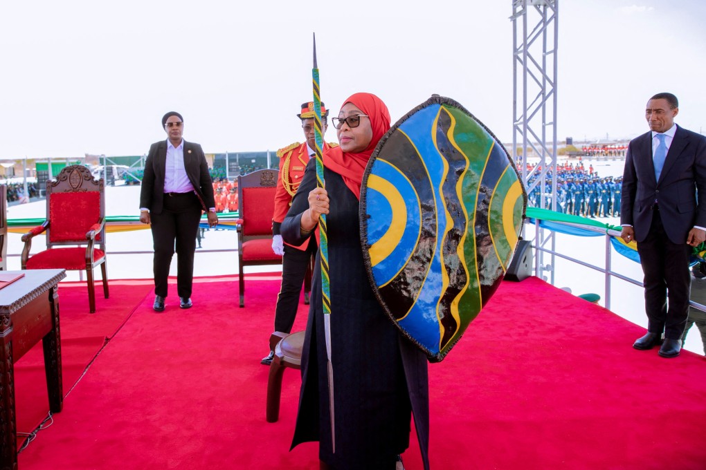 Tanzania’s President Samia Suluhu Hassan holds a spear and a shield during her swearing-in ceremony in Dodoma, Tanzania on Monday. Photo: Tanzania Presidential Press Unit via Reuters