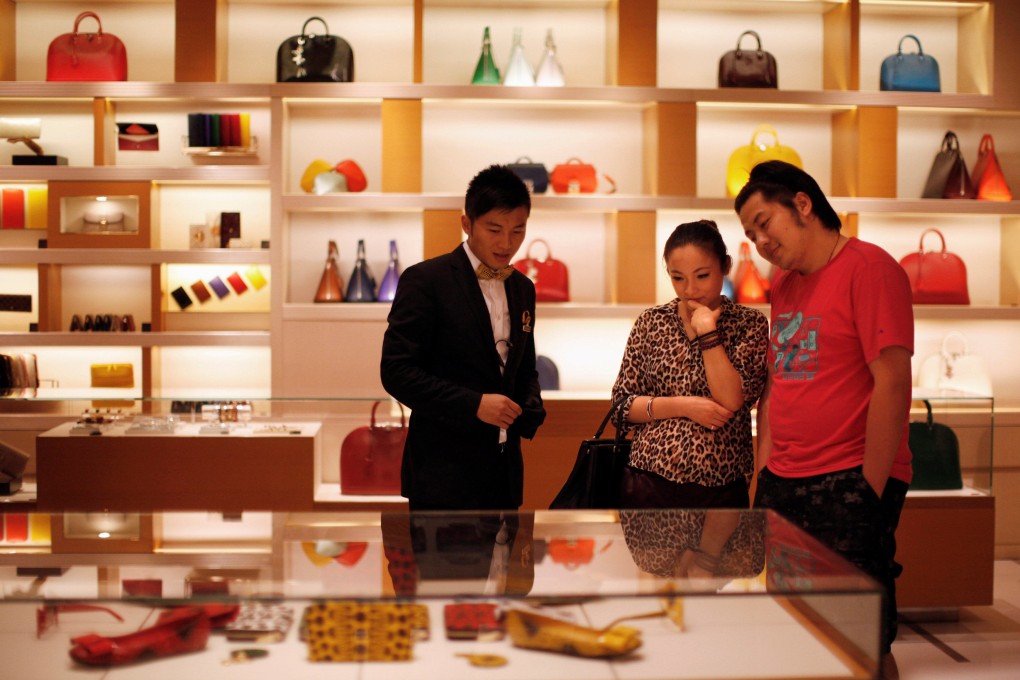 A couple shop at a Louis Vuitton store in Shanghai in 2012. Photo: Reuters