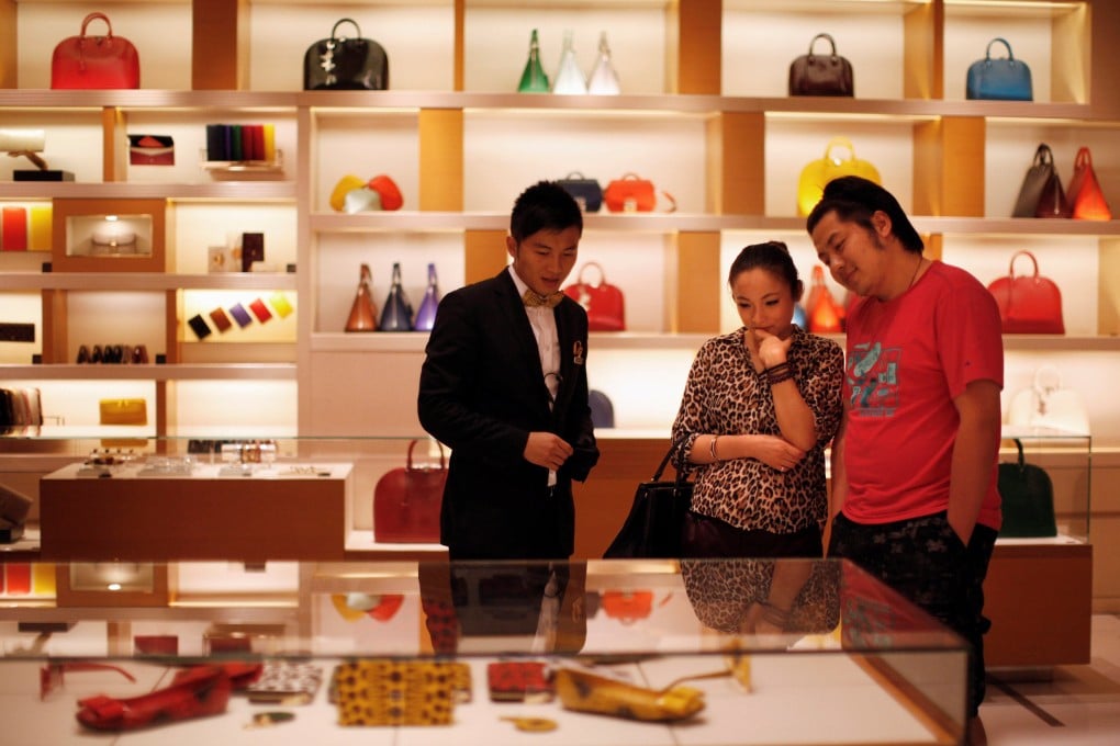 A couple shop at a Louis Vuitton store in Shanghai in 2012. Photo: Reuters