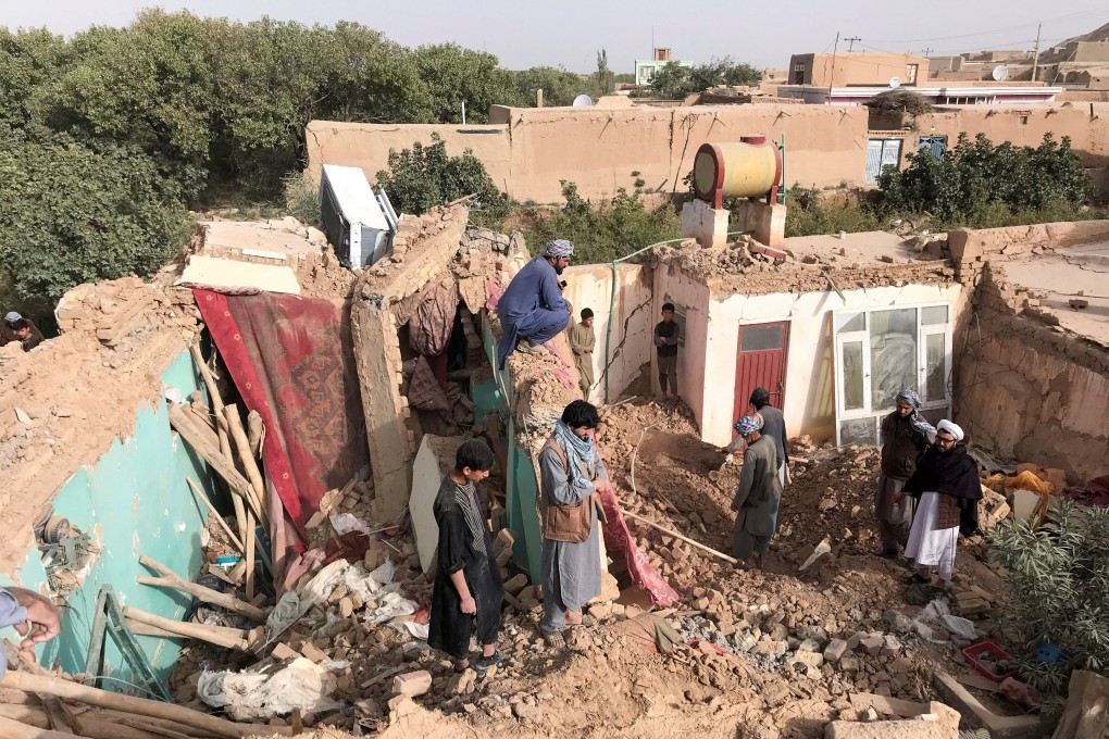 People stand on the debris of damaged buildings, in the aftermath of an earthquake in Samangan province, Afghanistan on Monday. Photo: Reuters