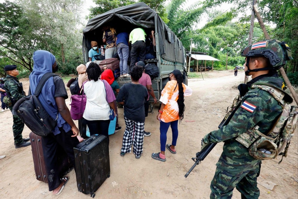 People, who were working in the KK Park scam compound in Myanmar and crossed to Thailand, board a vehicle in Mae Sot district, Tak province, on October 24. Photo: Thai News Pix/AFP