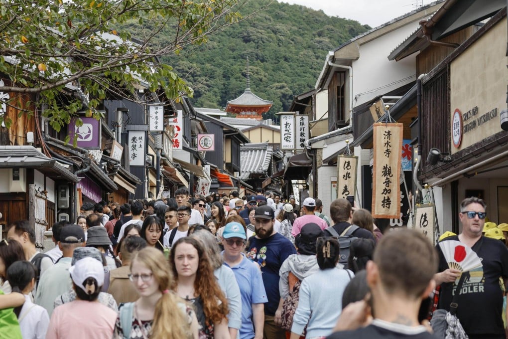 Foreigners crowd a street in Kyoto, western Japan, last month. Photo: Kyodo