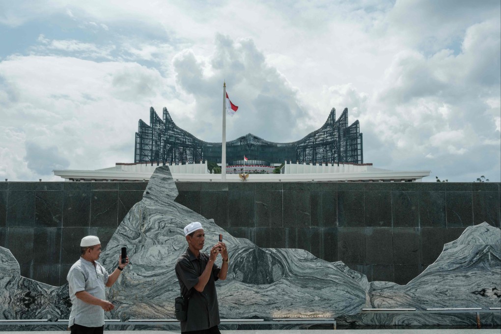People take pictures in front of the presidential palace in Nusantara, Indonesia’s future capital. Doubts persist over the future of the project that now faces waning political support from the current administration. Photo: AFP
