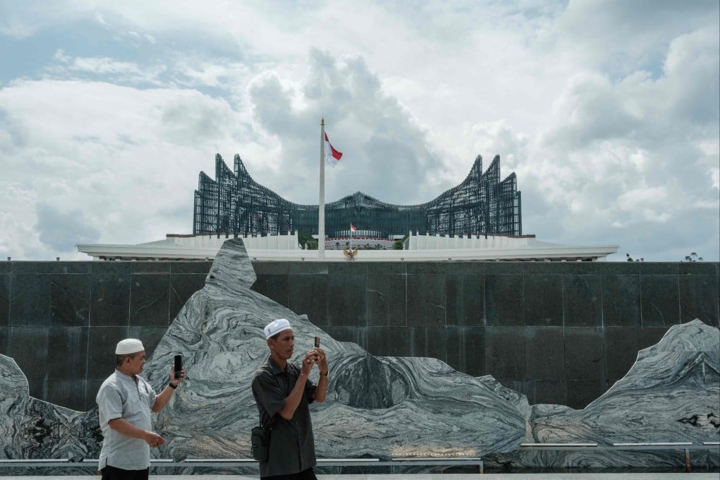 People take pictures in front of the presidential palace in Nusantara, Indonesia’s future capital. Doubts persist over the future of the project that now faces waning political support from the current administration. Photo: AFP