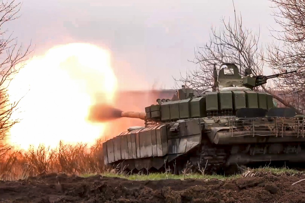 A Russian tank fires at Ukrainian troops from a position near the border with Ukraine in the Belgorod region of Russia last year. Photo: Russian Defense Ministry Press Service/AP