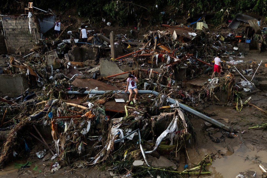 A woman sits on a fallen post amid the damage caused by Typhoon Kalmaegi in Cebu’s Talisay, Philippines, on Wednesday. Photo: Reuters