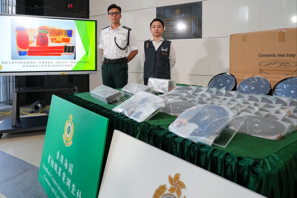Customs officers showcase the confiscated precious metals at a press conference. Photo: Sam Tsang