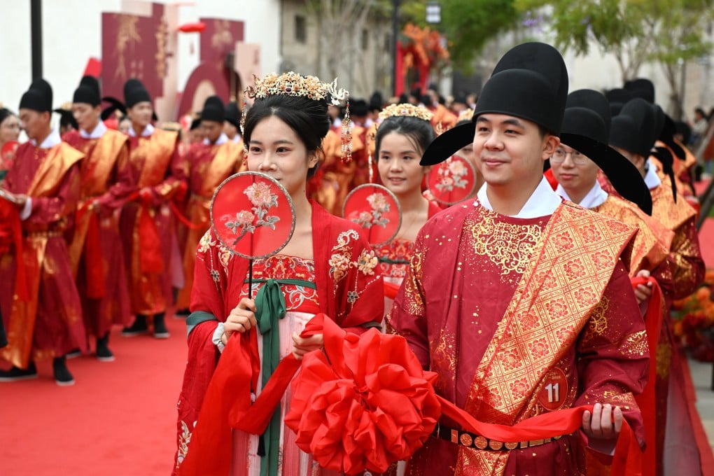 Couples dressed in Tang-style costumes participate in a group wedding ceremony in China’s southeastern Fujian province. Photo: Getty Images