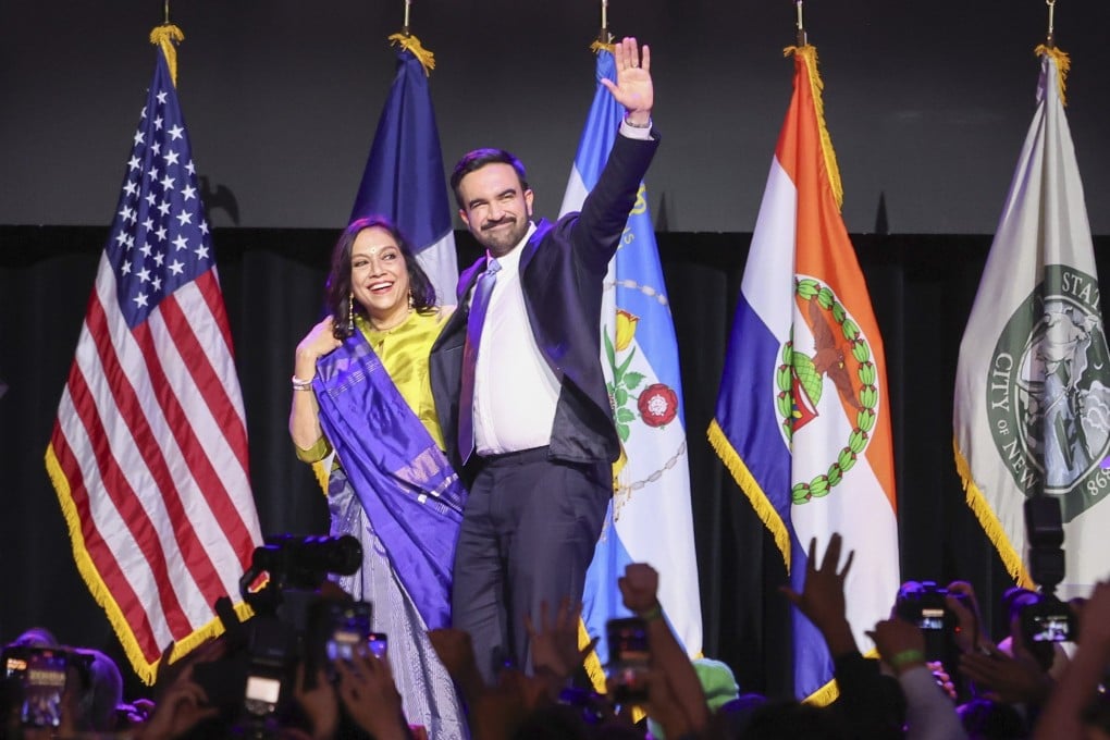 New York Mayor-elect Zohran Mamdani and his mother Mira Nair wave to the crowd during an election night party in Brooklyn on Tuesday. Photo: EPA