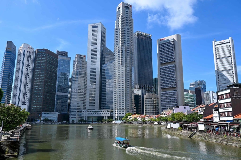 A boat cruises on the water in Singapore’s central business district. Photo: AFP
