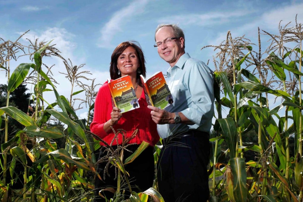 Farmers’ Almanac editor Sandi Duncan and publisher Peter Geiger pose in a corn field with the 2012 edition of the almanac. Photo: AP