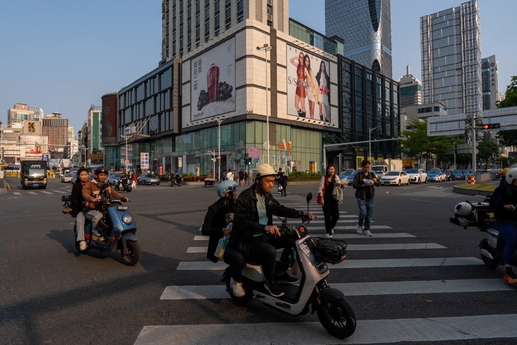 People cross a busy intersection in a shopping district in Shenzhen, Guangdong province. The southern Chinese region is struggling to boost local consumption as consumers remain cautious. Photo: Getty Images