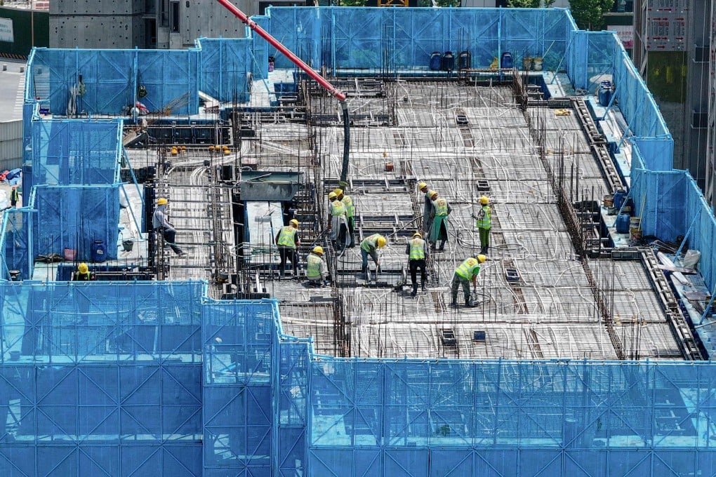 Workers are seen on a rooftop of a residential building under construction by Chinese property developer Poly Real Estate in Nanjing, in eastern China’s Jiangsu province, in May. Photo: AFP/China OUT