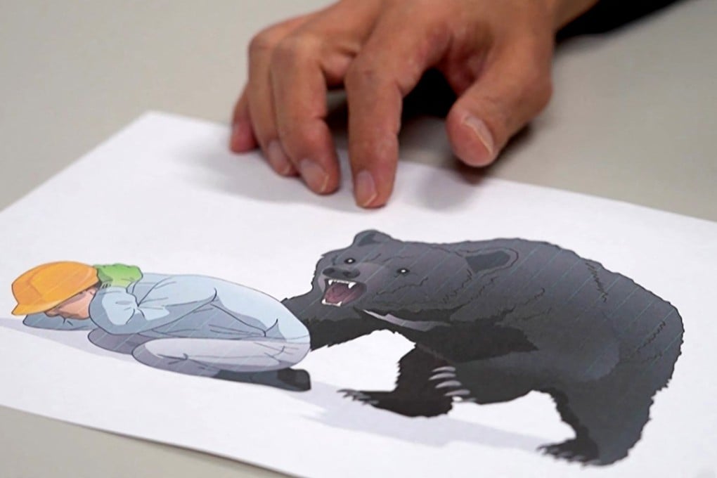 Japanese emergency doctor Hajime Nakae shows an illustration about bear attack safety at Akita University Hospital. Photo: AFTV/AFP