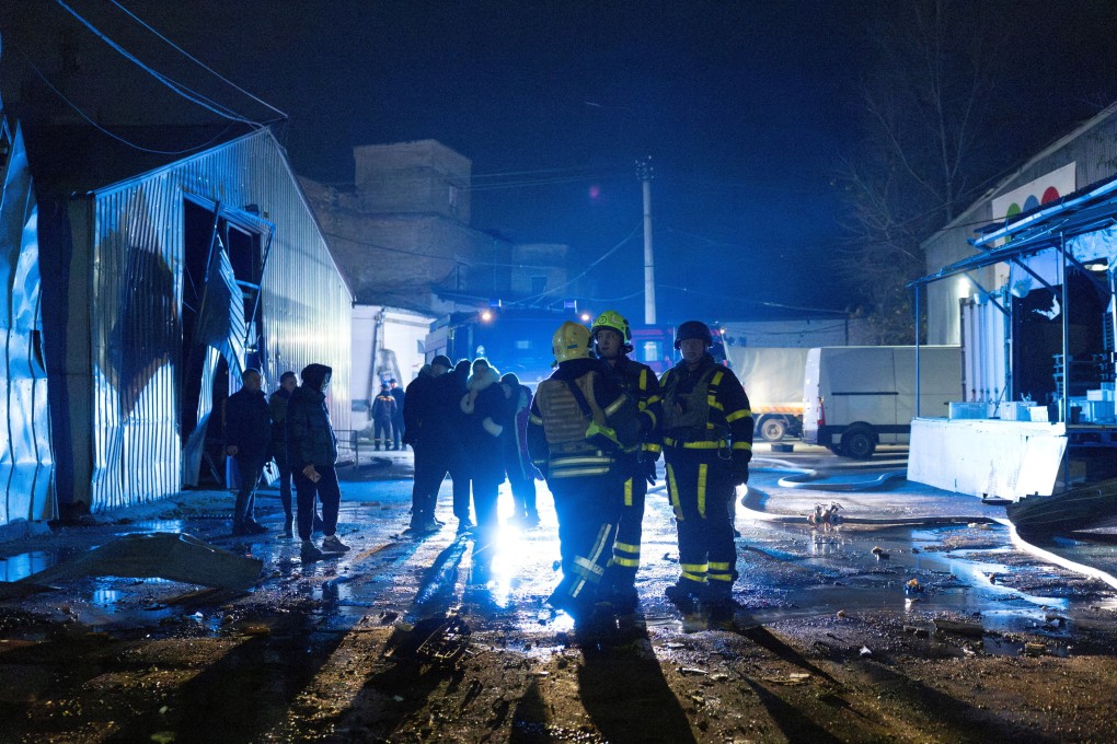 Firefighters stand at an impact site after a Russian drone attack in Kyiv, Ukraine on Saturday. Photo: Reuters