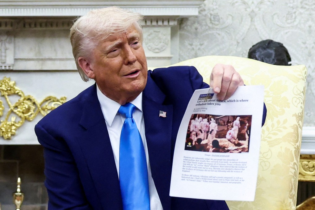 US President Donald Trump shows a copy of an article that he said its about white South Africans who had been killed, in the Oval Office in May. Photo: Reuters