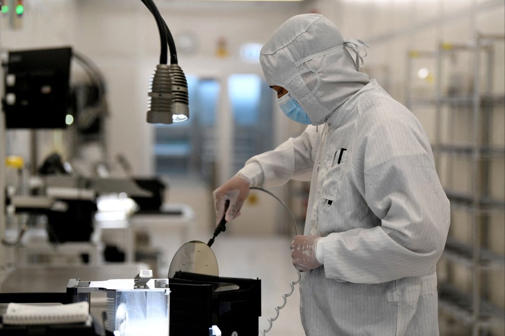 An employee works with a wafer in a production line of Dutch semiconductor company Nexperia in Hamburg, Germany. File photo: Reuters