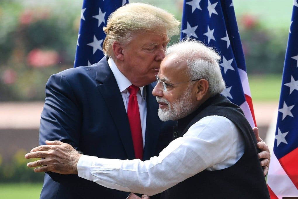 India’s Prime Minister Narendra Modi and US President Donald Trump embrace during a joint press conference at Hyderabad House in New Delhi on February 25, 2020. Photo: AFP