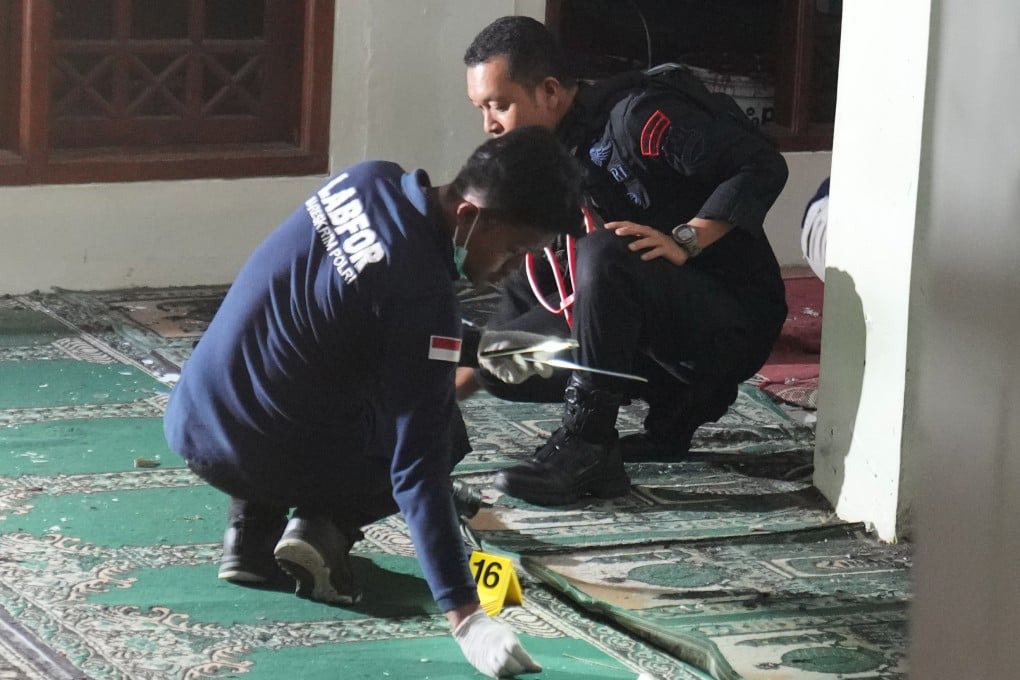 Members of the Indonesian police bomb squad inspect the mosque where explosions went off on Friday. Photo: AP