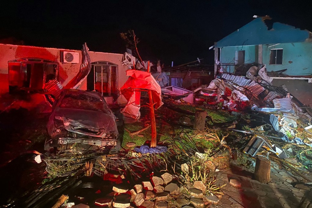 Damaged vehicles and buildings are seen in Rio Bonito do Iguacu in Brazil on Friday. Photo:Parana State Government via AFP