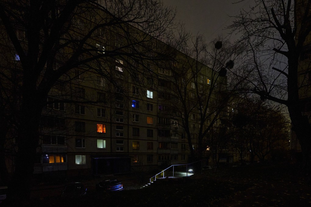 People walk with flashlights on a dark street during a blackout in Kharkiv, Ukraine, on Saturday. Photo: EPA