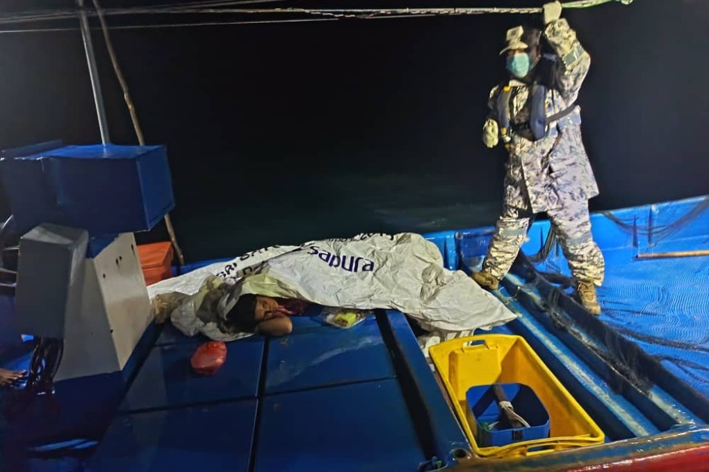 A survivor (left) rests aboard a boat in the waters off Kedah, Malaysia, on Sunday. Photo: Malaysian Maritime Enforcement Agency/Xinhua