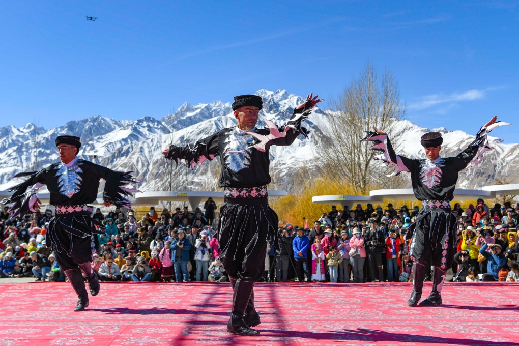 Actors perform an eagle dance in Taxkorgan Tajik autonomous county, Xinjiang Uygur autonomous region, in March while spectators look on. Photo: Xinhua