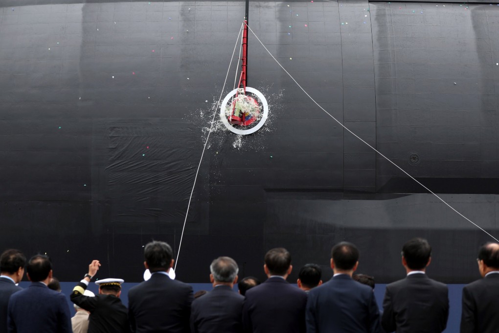 A bottle of champagne is smashed on the hull of South Korea’s first 3,600-ton-class naval submarine during a ceremony held at the Hanwha Ocean dockyard, in Geoje, South Korea, October 22. Photo: Photo: EPA/Yonhap