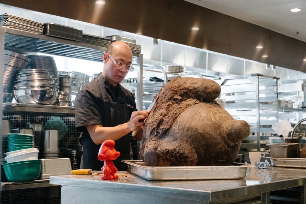 Pastry chef Michel Lo shapes a chocolate statue of The Smurfs that will weigh over 70 kilograms when completed. Photo: Sarah Kohler