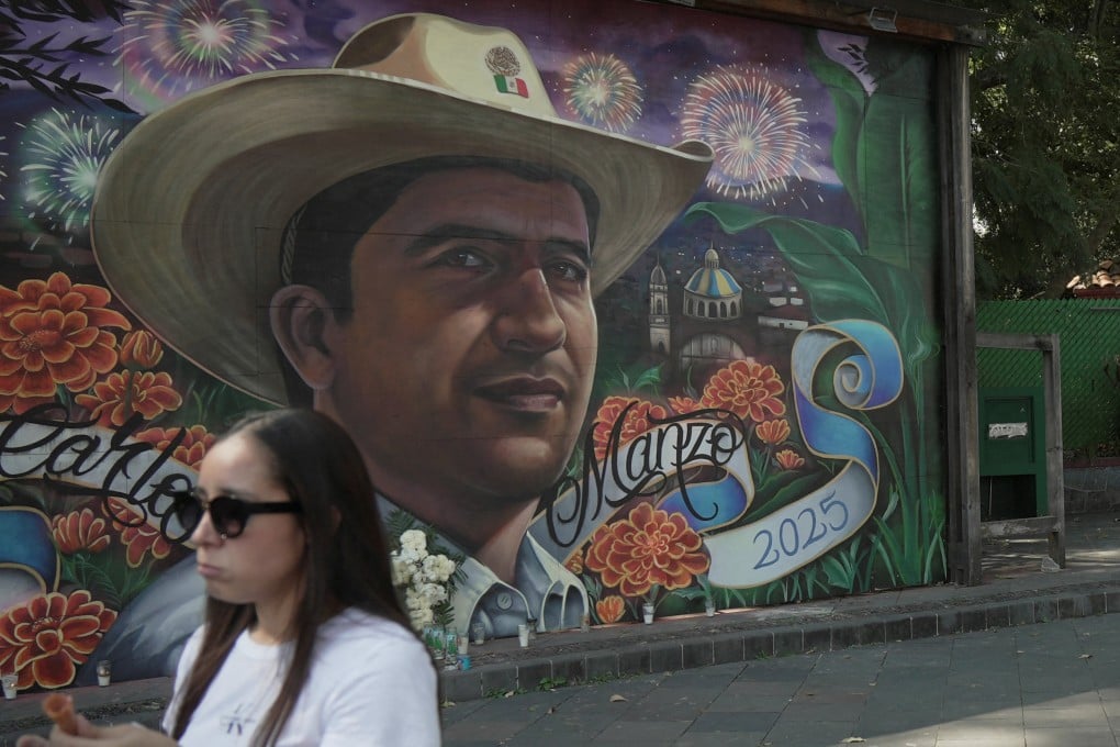 A woman walks past a mural depicting late Mayor Carlos Manzo, who was killed during a Day of the Dead event, in Uruapan, Mexico on Friday. Photo: Reuters
