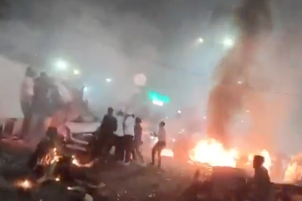 Flames and smoke billow from cars on a crowded street after an explosion in New Delhi on Monday. Photo: Handout