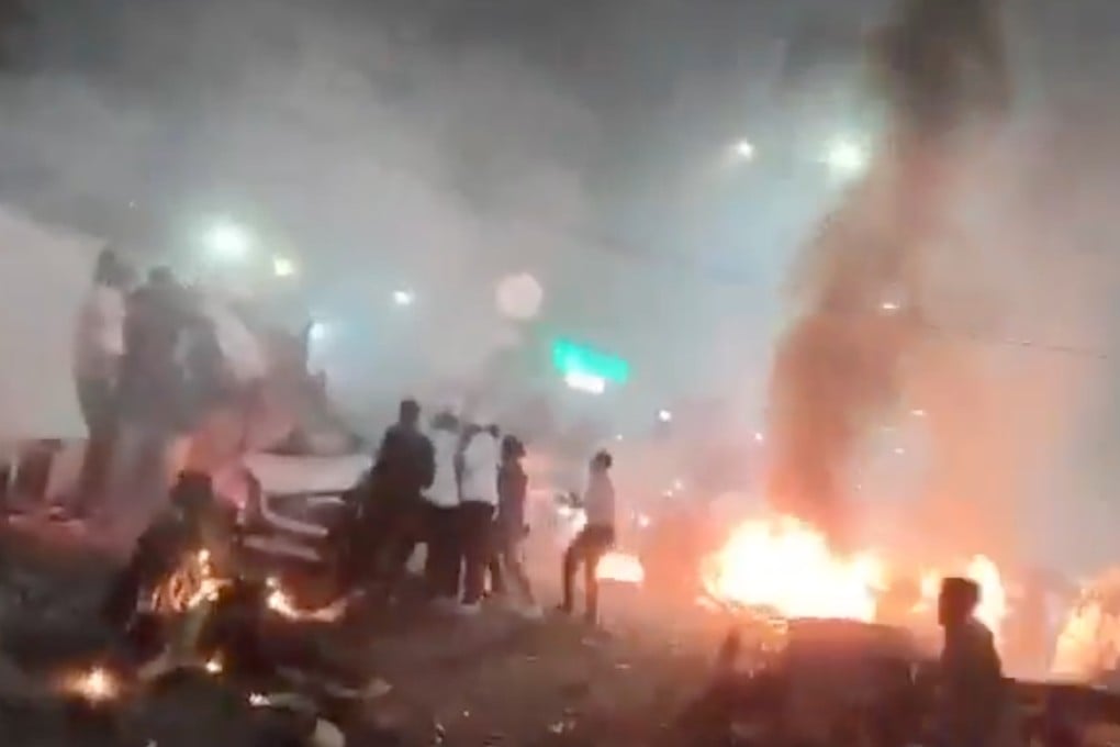 Flames and smoke billow from cars on a crowded street after an explosion in New Delhi on Monday. Photo: Handout