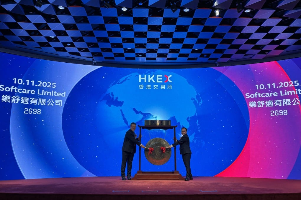 Softcare chairman Shen Yanchang (left) and CEO Luo Jichao strike the gong at the company’s listing ceremony on the Hong Kong stock exchange on Monday. Photo: Yulu Ao