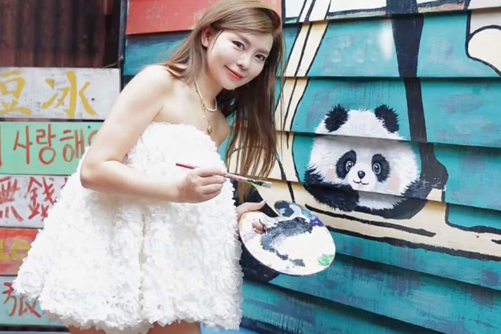 Shi Shi with her finished painting of a panda. Photo: Handout