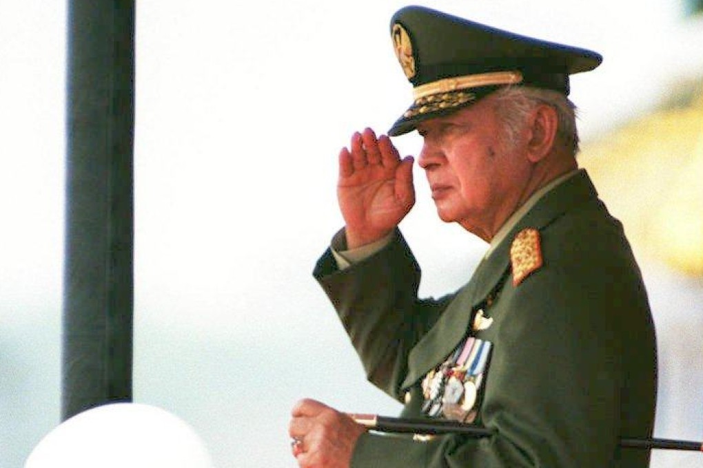Indonesian President Suharto, in full military uniform, salutes an armed forces’ parade on October 5, 1997. Photo: AFP